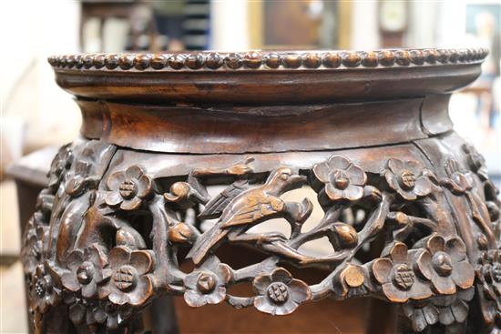 A pair of 19th century Chinese carved hardwood jardiniere stands